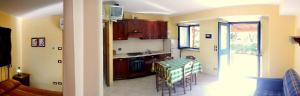 a kitchen with a table and chairs in a room at Agriturismo Colomboni in San Costanzo