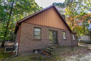 a small brick house with a staircase in front at Sylvan drive 18793 in Rehoboth Beach