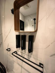 a bathroom with a mirror and a towel rack at UNDD Rouge in Jeddah