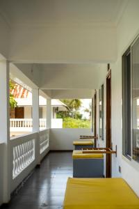 a row of chairs on a balcony with a window at Mem Luxury Apartments and Hotel in Paje
