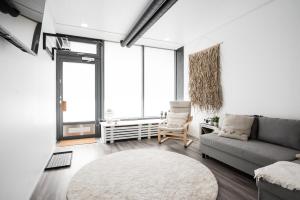 a living room with a couch and a chair at Urban Courtyard Lahti 2 in Lahti +19 photos