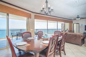 a dining room with a table and chairs and a couch at Sonoran Sky in Puerto Peñasco