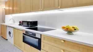 a kitchen with a bowl of fruit on a counter at Alpine Casa Vacanze Domenion Livigno in Livigno +3 photos