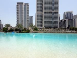 a large swimming pool in a city with tall buildings at GuestReady - Lux living with an infinity pool in Dubai