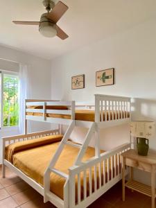 a bedroom with two bunk beds and a ceiling fan at LA HACIENDA GOLF Apartamento Nuevo con WIFI y AIRE ACONDICIONADO -SOLO FAMILIAS O PAREJA- NO GRUPOS- in Islantilla +40 photos