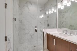 a bathroom with a shower and a sink and a mirror at Ocean Park 08 in San Diego +66 photos
