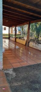 an empty patio with a building with glass windows at Cabaña Familiar con arroyo sobre Ruta 12 II in Santa Ana