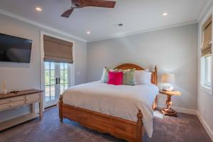 a bedroom with a large bed and a flat screen tv at Bella Vita in Paso Robles