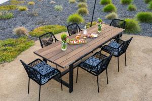 a wooden table with chairs and food on it at Memory M Acres in Paso Robles