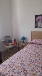 a bedroom with a bed and a chair and a table at Belvedere Experience Apartment in Caprioli