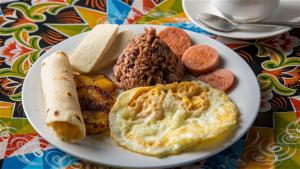 a plate of food with eggs and bread on a table at Romantic Cabin in the Forest, Valle Azul, Bungalows Tulipanes CR in San Ramón +10 photos