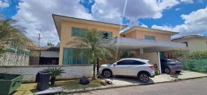 a white car parked in front of a house at Cop 30 - Casa em Condominio Oasis in Ananindeua