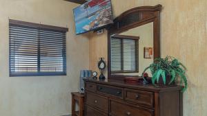 a room with a mirror and a dresser with a plant on it at Sonoran Sky in Puerto Peñasco +19 photos