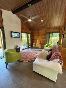 a bedroom with a bed and a tv in it at Romantic Cabin in the Forest, Valle Azul, Bungalows Tulipanes CR in San Ramón