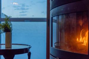 a room with a fireplace with a table and a window at 源泉かけ流し温泉付き一棟貸しVilla Gensen Two in Yuzawa +41 photos