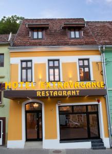 a building with a sign that reads hotel engineering reference restaurant at Extravagance Hotel in Sighişoara