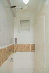 a bathroom with a shower and a sink and a window at Perfect Stay for All Near Malls Attractions Free Parking in Ongata Rongai  +36 photos