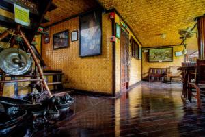 a room with a hallway with a table and chairs at Puerto Pension Inn in Puerto Princesa City