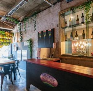 a restaurant with a bar and a table with chairs at Stay Hyun in Jeju