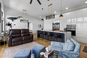 a kitchen and living room with a couch and chairs at Flatrock Ocean View Sauna 3B 35BA in Flat Rock