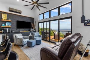 a living room with a couch and chairs and a television at Flatrock Ocean View Sauna 3B 35BA in Flat Rock