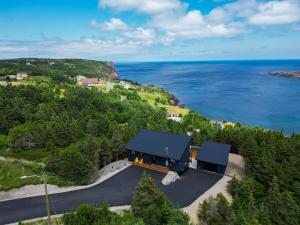 an aerial view of a house with the ocean at Flatrock Ocean View Sauna 3B 35BA in Flat Rock