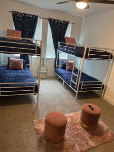 a room with three bunk beds and two stools at Cozy Contemporary Condo in Atlanta +30 photos