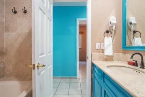 a bathroom with a sink and a blue door at Sonoran Sea in Campo del Medio +26 photos