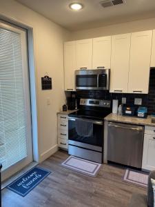 a kitchen with a stove and a microwave at Peaceful Pad on Peters in Atlanta