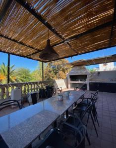 a patio with a table and chairs and a grill at Hotel Sienna in Mendoza