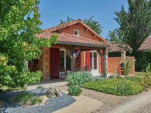 a small red house with a garden at Villa in France with Garden & Barbecue in Les Forges