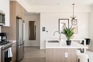a kitchen with a stainless steel refrigerator and a sink at Serenity in Style | Espadin LoHi in Denver