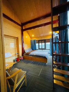 a bedroom with a bed in a wooden cabin at Săn Mây Homestay and Coffee Măng Đen in Kon Tum +20 photos