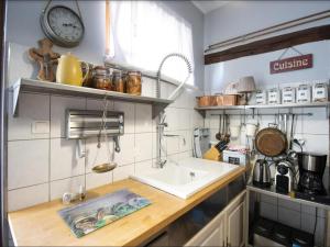 a kitchen with a sink and a counter top at Holiday flat in Morschwiller in Morschwiller
