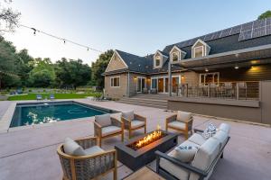 a backyard with a fire pit and a house at Sycamore Ranch in Templeton