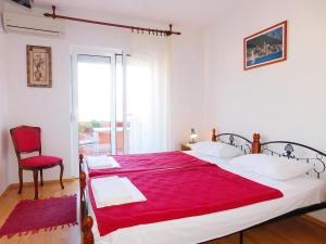 a bedroom with two beds with a red blanket at Villa Jovana Sea View in Budva