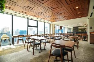 a restaurant with tables and chairs and large windows at Solaria Nishitetsu Hotel Seoul Myeongdong - Renovated in 2025 in Seoul