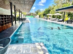 a swimming pool with blue water in a resort at Awa C-103 in Playa del Carmen