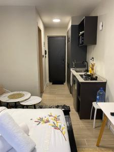 a small apartment kitchen with a sink and a table at Sure Stay Homes in Marimbeti +22 photos