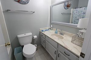 a bathroom with a toilet and a sink and a mirror at The Peaceful One in Foley +21 photos