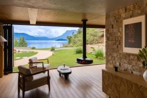 a living room with a large window with a view of a lake at Lugu Lake Manchen Vacation Homestay in Ninglang