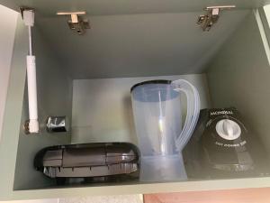 a blender and a juicer sitting on a shelf at Chalé Village da Serra in Serra de São Bento