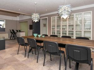 a dining room with a large wooden table and chairs at 4 star holiday home in Henne in Henne +74 photos
