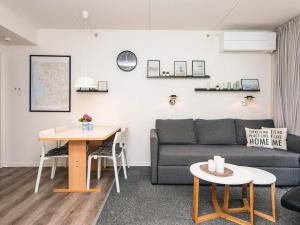 a living room with a couch and a table at 4 person holiday home in Ringkøbing in Ringkøbing +34 photos