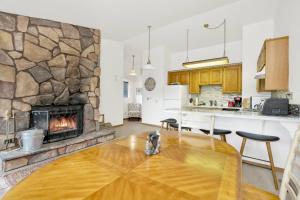 a kitchen and living room with a stone fireplace at Bear meadow woods condo #2341 in Big Bear Lake +9 photos