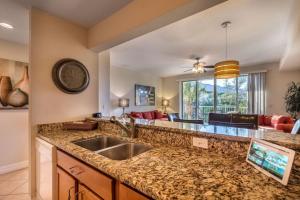 a kitchen with a sink and a living room at Bahia Beach Townhome in Ruskin