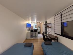 a small room with two beds and a kitchen at Luxury studio Évry - Ris, 25 min to Paris in Ris-Orangis