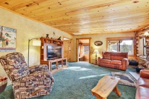 a living room with a couch and a tv at Pleasant Pause#1864 in Fawnskin