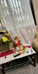 a table with a figurine on it in front of a window at House in Chocolate Hills carmen Bohol in Carmen