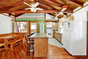 a kitchen with a white refrigerator and a table at Moonlight ridge - 1929 in Big Bear Lake